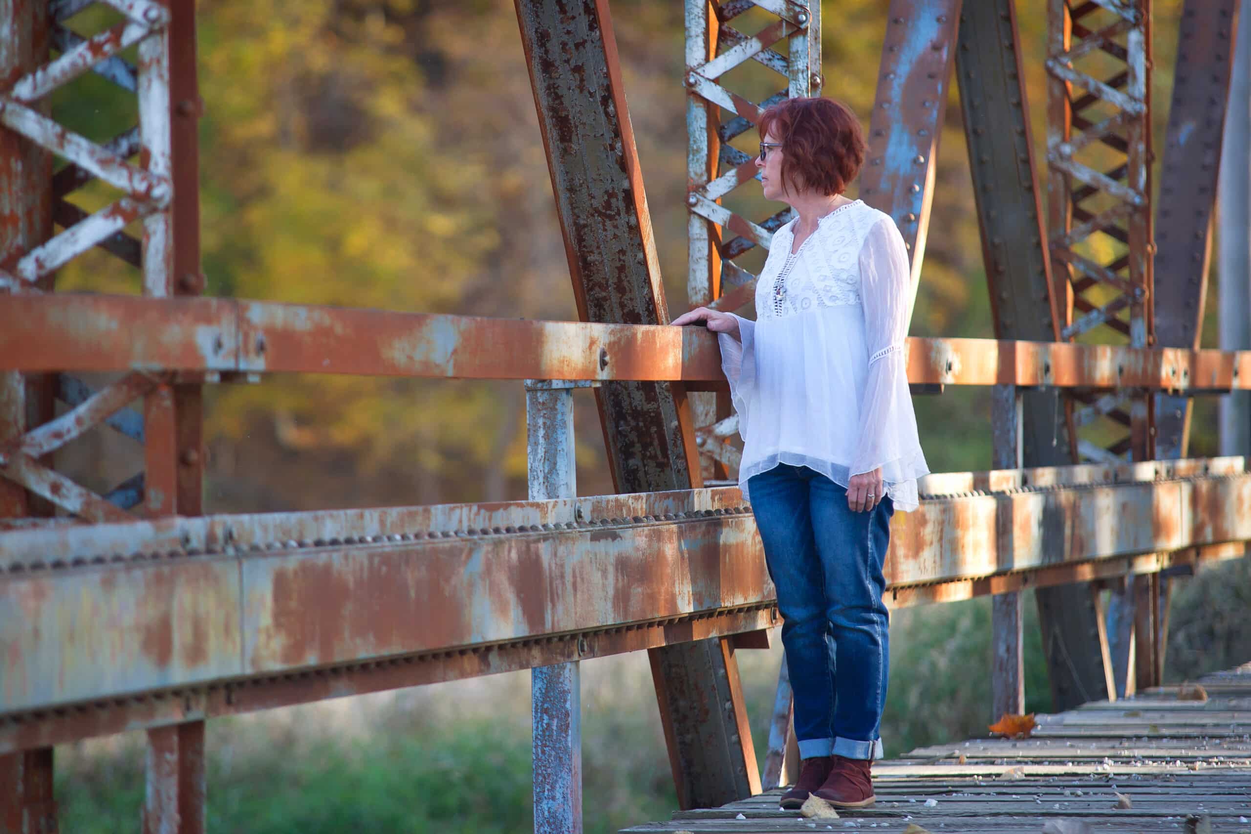 Cheryl Kearns on rustic bridge